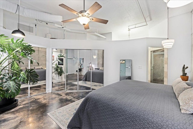 311 W 5th St Unit 1008, Austin, TX 78701 - bedroom featuring concrete floors, a towering ceiling, and two closets