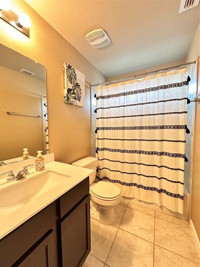 125 Duck Creek Trl, San Marcos, TX 78666 - full bathroom featuring vanity, shower / bath combination with curtain, a textured ceiling, and tile patterned flooring