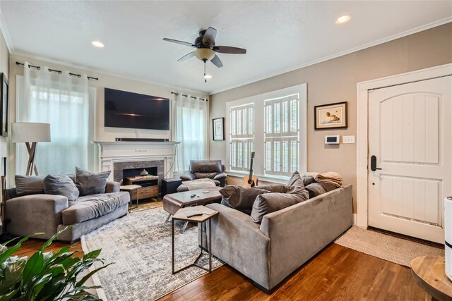 1508 Pease Rd, Austin, TX 78703 - living area with dark wood-style flooring, ceiling fan, ornamental molding, a high end fireplace, and recessed lighting
