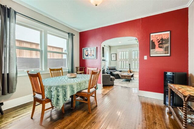 1508 Pease Rd, Austin, TX 78703 - dining area featuring arched walkways, hardwood / wood-style floors, and crown molding