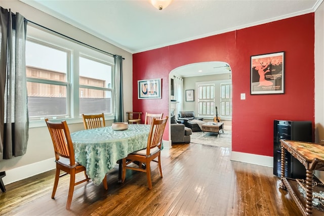 1508 Pease Rd, Austin, TX 78703 - dining space featuring arched walkways, hardwood / wood-style floors, and crown molding