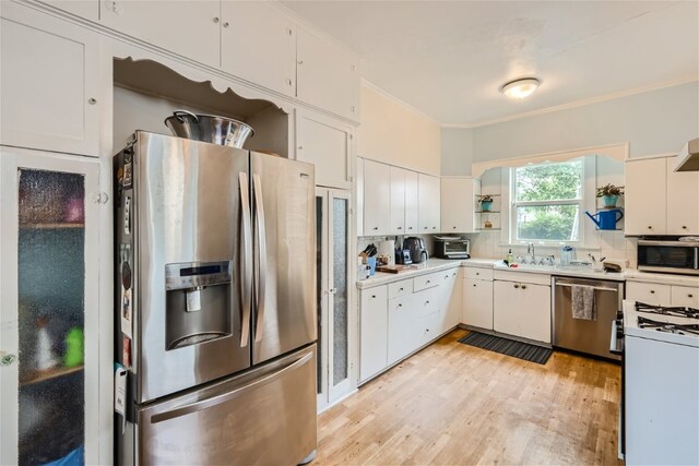1508 Pease Rd, Austin, TX 78703 - kitchen featuring stainless steel appliances, open shelves, light wood finished floors, tasteful backsplash, and ornamental molding