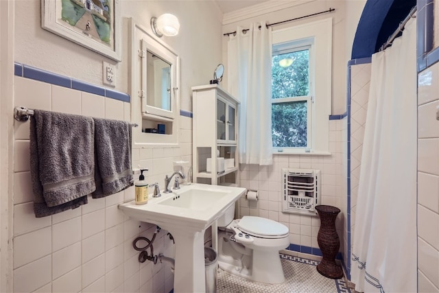 1508 Pease Rd, Austin, TX 78703 - full bathroom with tile walls, heating unit, a shower with shower curtain, tile patterned flooring, and wainscoting