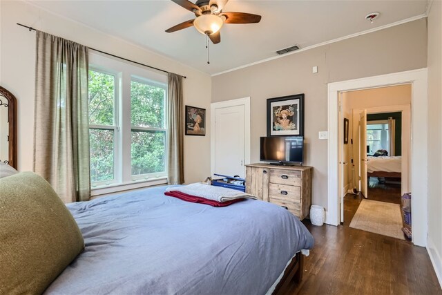 1508 Pease Rd, Austin, TX 78703 - bedroom with dark wood finished floors, ornamental molding, and a ceiling fan
