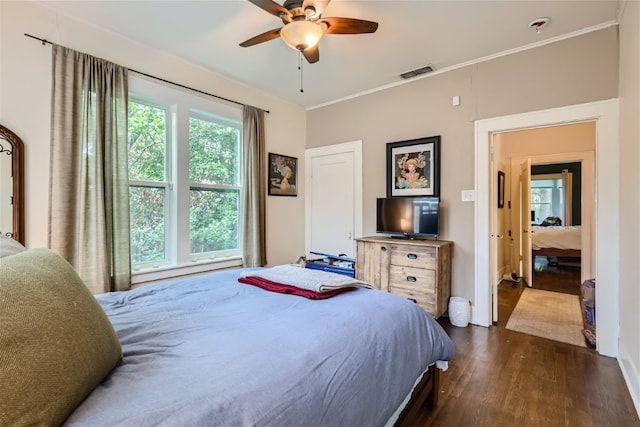 1508 Pease Rd, Austin, TX 78703 - bedroom with dark wood-style floors, crown molding, and ceiling fan