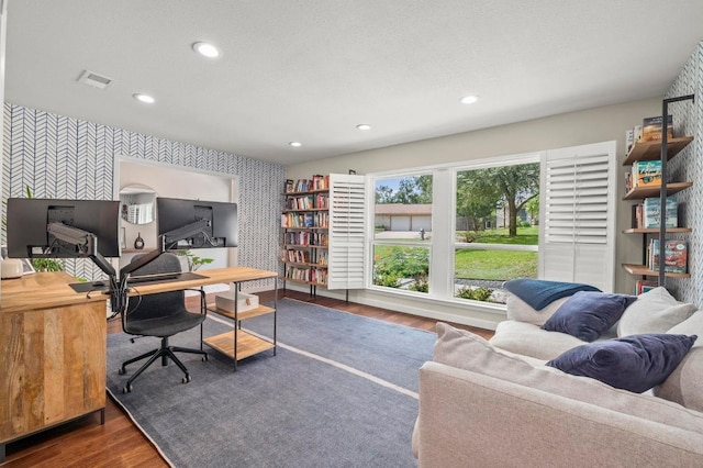 8714 Silverhill Ln, Austin, TX 78759 - home office featuring wallpapered walls, an accent wall, wood finished floors, and recessed lighting