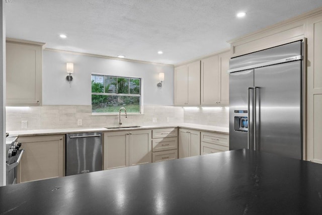 406 N Coronado Dr, Kerrville, TX 78028 - kitchen featuring high end appliances, decorative backsplash, recessed lighting, ornamental molding, and cream cabinets