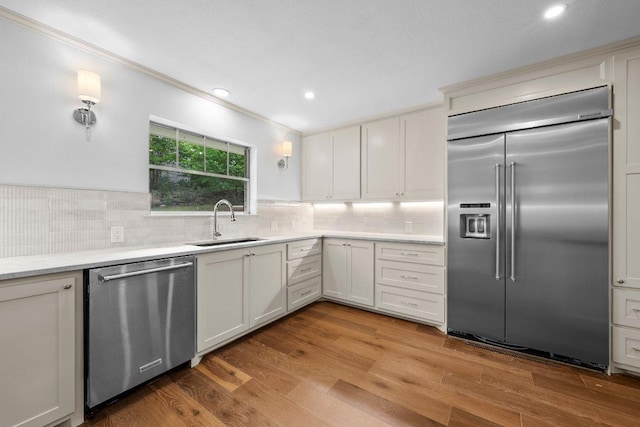 406 N Coronado Dr, Kerrville, TX 78028 - kitchen with appliances with stainless steel finishes, light countertops, backsplash, recessed lighting, and ornamental molding