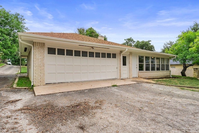 406 N Coronado Dr, Kerrville, TX 78028 - view of front of house with brick siding, a chimney, an attached garage, driveway, and a sunroom