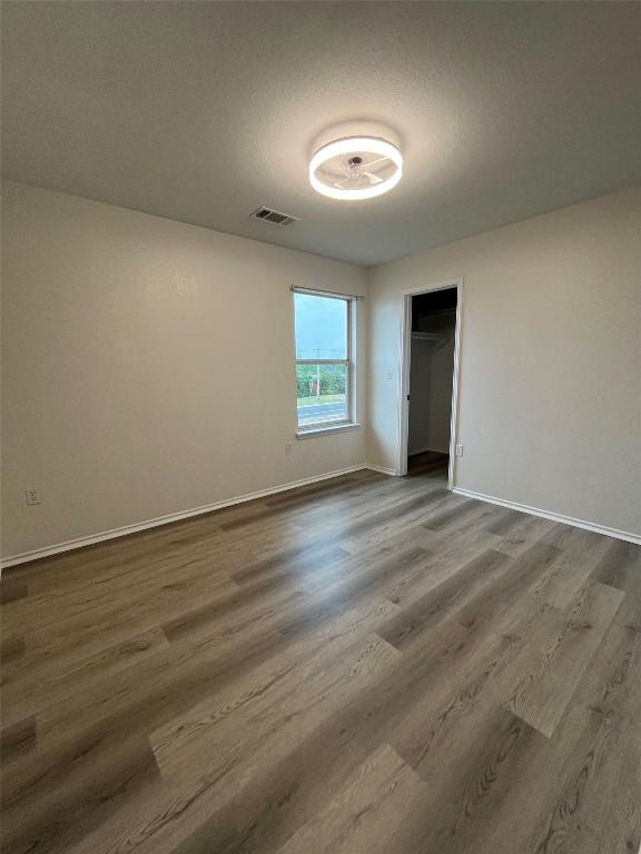 3016 Aftonshire Way, Austin, TX 78748 - unfurnished bedroom with dark wood-style floors and a closet