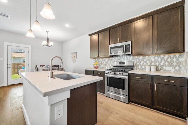 1516 Honaker Way, Leander, TX 78641 - kitchen with stainless steel appliances, light wood-style flooring, backsplash, and recessed lighting
