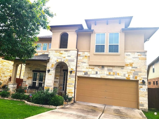 608 Cascada Ln, Round Rock, TX 78681 - view of front of home with stucco siding, a garage, stone siding, and concrete driveway