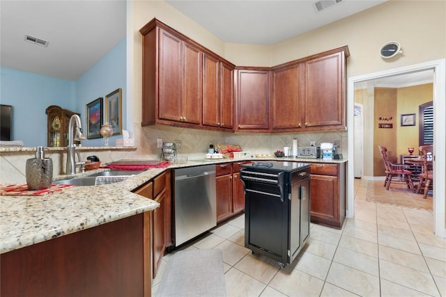 3516 Valley Mist Ct, Temple, TX 76502 - kitchen with stainless steel dishwasher, light stone countertops, tasteful backsplash, and light tile patterned floors