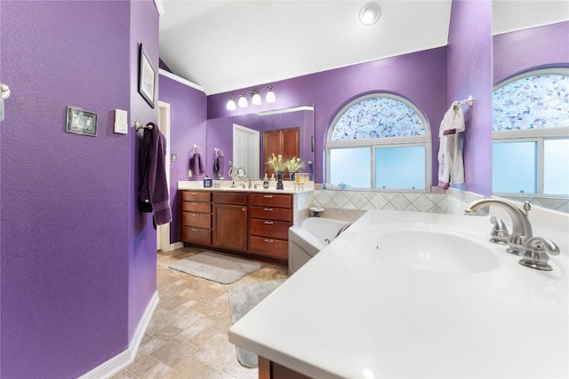 3516 Valley Mist Ct, Temple, TX 76502 - full bath with vanity, a tub, lofted ceiling, a textured wall, and stone finish floors