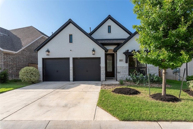 2624 San Bautista Way Unit 44, Leander, TX 78641 - view of front of home with driveway, a front lawn, and stone siding