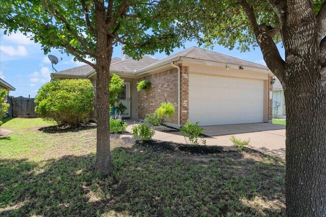 2321 Kale Dr, Austin, TX 78725 - ranch-style house with a garage, concrete driveway, and brick siding