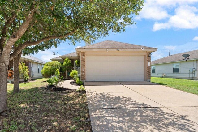 2321 Kale Dr, Austin, TX 78725 - ranch-style house featuring brick siding, a front lawn, concrete driveway, and a garage