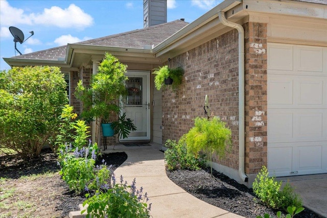 2321 Kale Dr, Austin, TX 78725 - entrance to property with an attached garage, brick siding, and a chimney
