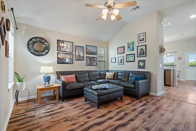 2321 Kale Dr, Austin, TX 78725 - living area featuring wood finished floors, lofted ceiling, a ceiling fan, and plenty of natural light