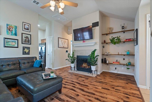 2321 Kale Dr, Austin, TX 78725 - living room with a fireplace, ceiling fan, wood finished floors, and vaulted ceiling
