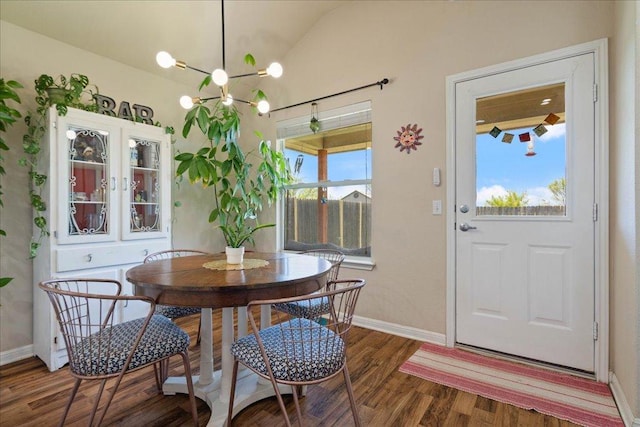 2321 Kale Dr, Austin, TX 78725 - dining room featuring wood finished floors, a chandelier, and lofted ceiling