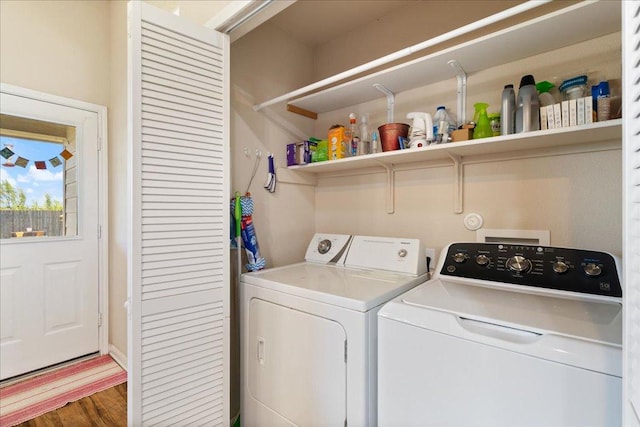 2321 Kale Dr, Austin, TX 78725 - laundry area featuring washing machine and clothes dryer and wood finished floors