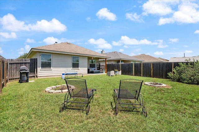 2321 Kale Dr, Austin, TX 78725 - rear view of house featuring a fenced backyard and an outdoor living space with a fire pit