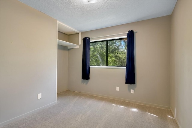 8702 Wildridge Dr, Austin, TX 78759 - carpeted empty room with a textured ceiling and baseboards