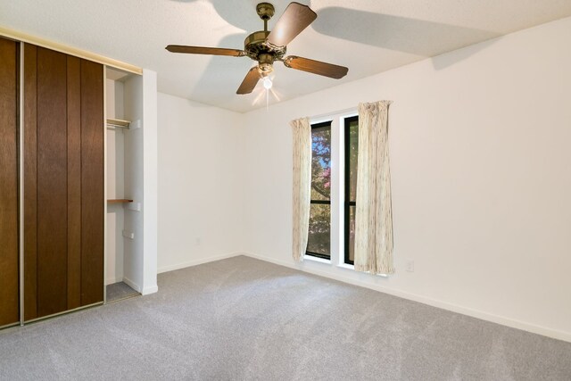 8702 Wildridge Dr, Austin, TX 78759 - unfurnished bedroom with carpet flooring, a closet, and a ceiling fan