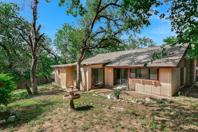 8702 Wildridge Dr, Austin, TX 78759 - rear view of house with a shingled roof and a patio