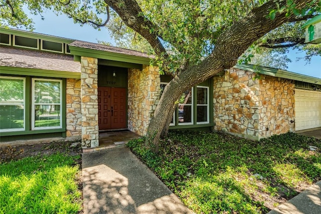 7507 Valburn Dr, Austin, TX 78731 - entrance to property with stone siding and an attached garage