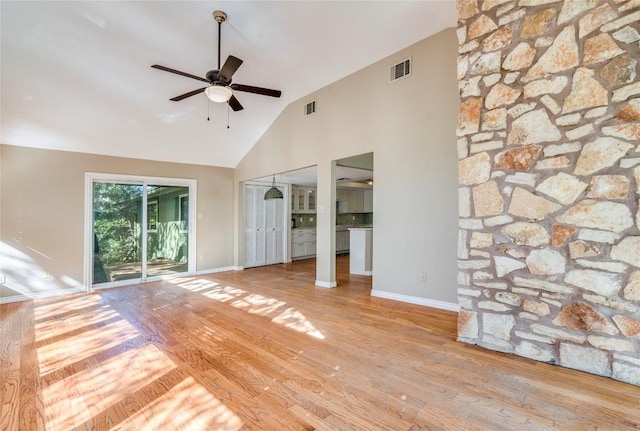 7507 Valburn Dr, Austin, TX 78731 - unfurnished living room featuring ceiling fan, wood finished floors, and high vaulted ceiling