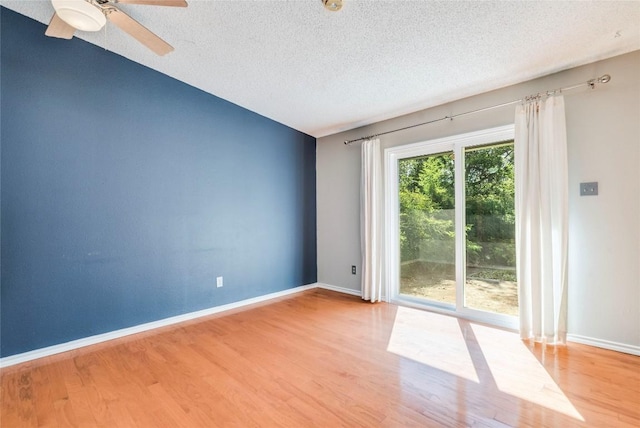 7507 Valburn Dr, Austin, TX 78731 - empty room featuring a textured ceiling, wood finished floors, and a ceiling fan