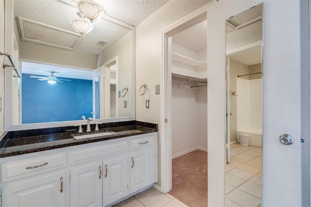 7507 Valburn Dr, Austin, TX 78731 - bathroom featuring vanity, a walk in closet, and tile patterned floors