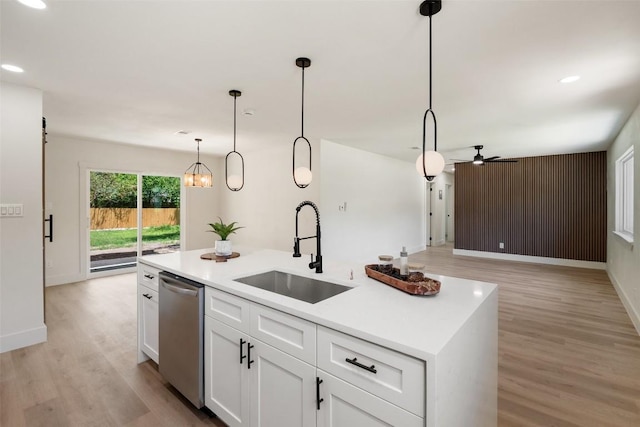 5603 Darlington Ln, Austin, TX 78723 - kitchen with dishwasher, light wood-style floors, a ceiling fan, white cabinets, and pendant lighting