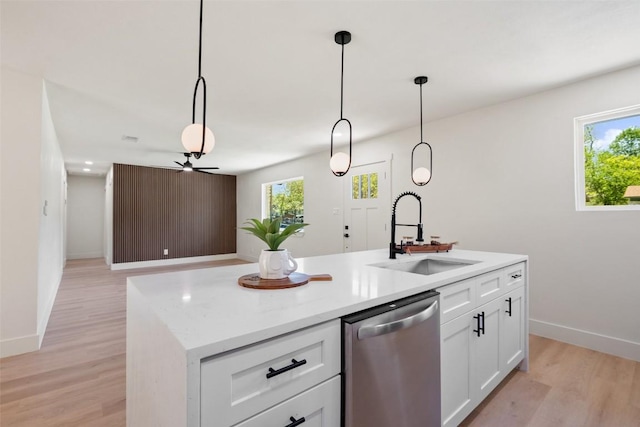 5603 Darlington Ln, Austin, TX 78723 - kitchen featuring stainless steel dishwasher, light wood-style flooring, and plenty of natural light