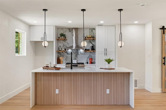 5603 Darlington Ln, Austin, TX 78723 - kitchen featuring wall chimney exhaust hood, open shelves, light wood-style floors, white cabinetry, and recessed lighting