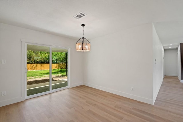 5603 Darlington Ln, Austin, TX 78723 - spare room with light wood-style flooring and a chandelier