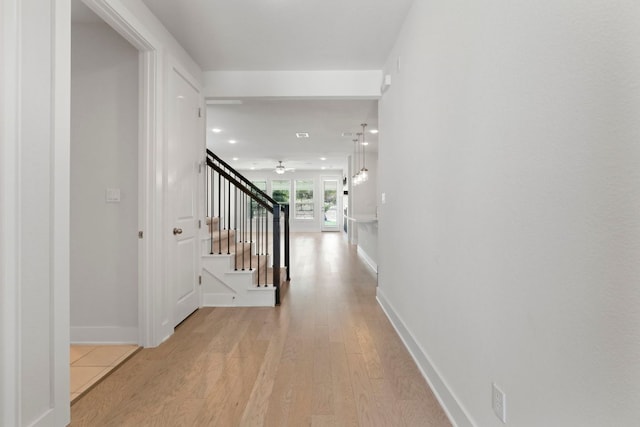 265 Tierra Trl, Dripping Springs, TX 78620 - hallway with light wood-type flooring, stairs, and recessed lighting