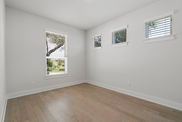 265 Tierra Trl, Dripping Springs, TX 78620 - unfurnished room featuring wood finished floors and plenty of natural light