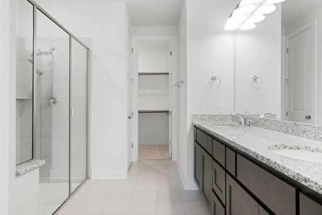 265 Tierra Trl, Dripping Springs, TX 78620 - full bath featuring a stall shower, double vanity, a spacious closet, and tile patterned flooring