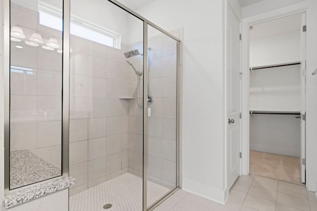 265 Tierra Trl, Dripping Springs, TX 78620 - full bathroom with a shower stall, a walk in closet, and tile patterned flooring