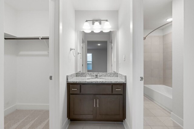 265 Tierra Trl, Dripping Springs, TX 78620 - bathroom featuring bathtub / shower combination, vanity, tile patterned floors, and a walk in closet