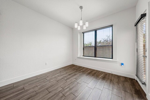 12315 Maypole Bnd Unit 1002, Austin, TX 78717 - unfurnished dining area with dark wood finished floors and a chandelier