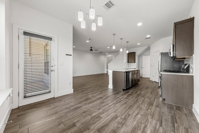 12315 Maypole Bnd Unit 1002, Austin, TX 78717 - kitchen with open floor plan, dark brown cabinets, light countertops, dark wood-type flooring, and recessed lighting
