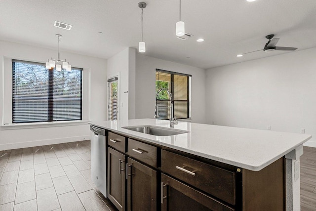 12315 Maypole Bnd Unit 1002, Austin, TX 78717 - kitchen featuring dishwasher, dark brown cabinets, pendant lighting, an island with sink, and a chandelier