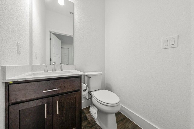 12315 Maypole Bnd Unit 1002, Austin, TX 78717 - bathroom with a textured wall, vanity, and wood finished floors