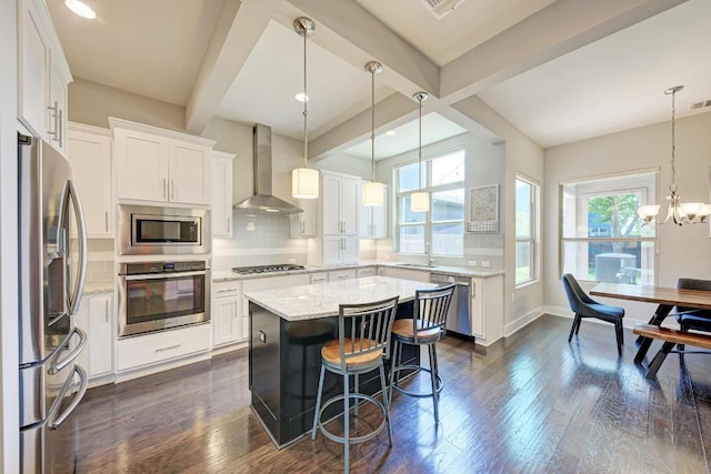 3105 Mccurdy St, Austin, TX 78723 - kitchen with stainless steel appliances, wall chimney exhaust hood, beamed ceiling, white cabinetry, and tasteful backsplash