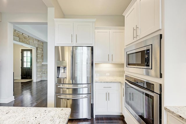 3105 Mccurdy St, Austin, TX 78723 - kitchen with appliances with stainless steel finishes, dark wood-style floors, and white cabinets