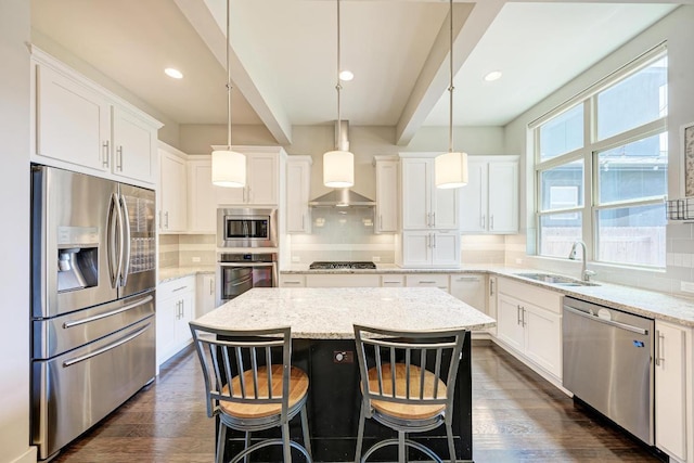 3105 Mccurdy St, Austin, TX 78723 - kitchen with appliances with stainless steel finishes, decorative backsplash, a center island, white cabinets, and decorative light fixtures